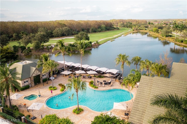 view of swimming pool featuring a patio and a water view