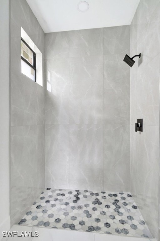 bathroom with a tile shower