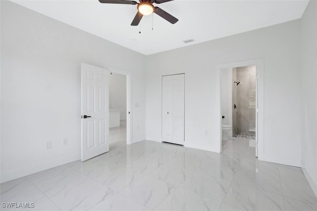 unfurnished bedroom featuring ensuite bath, ceiling fan, and a closet