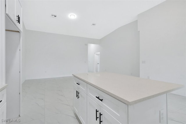 kitchen with a center island and white cabinetry