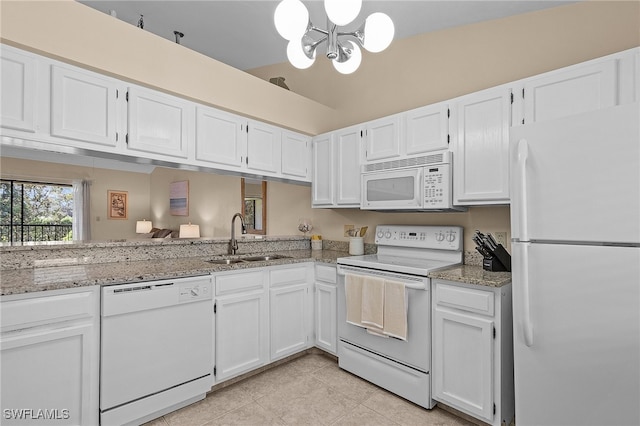 kitchen featuring sink, white cabinetry, white appliances, and vaulted ceiling