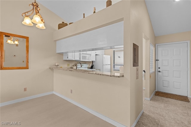 kitchen featuring lofted ceiling, hanging light fixtures, an inviting chandelier, white cabinets, and white appliances