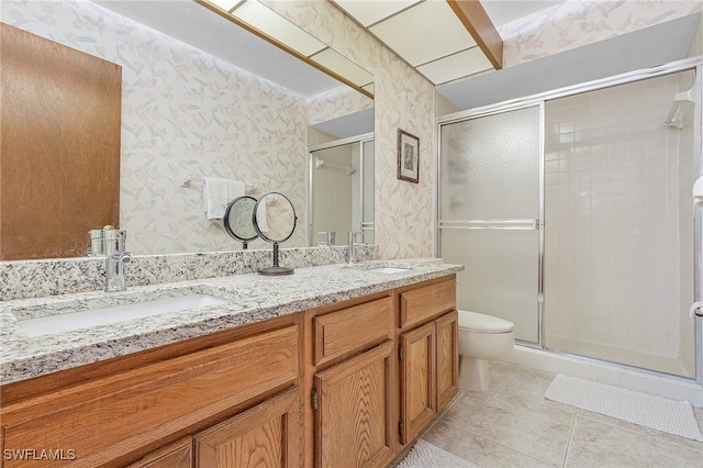 bathroom featuring vanity, walk in shower, toilet, and tile patterned flooring