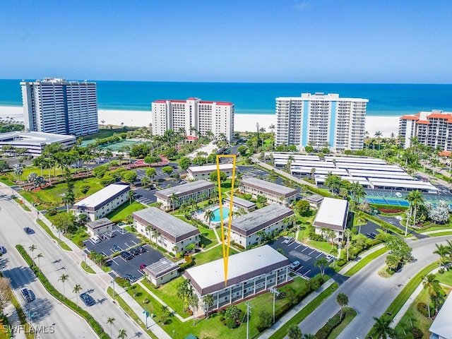 birds eye view of property featuring a water view and a view of the beach