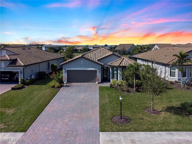 view of front of home featuring a garage and a lawn