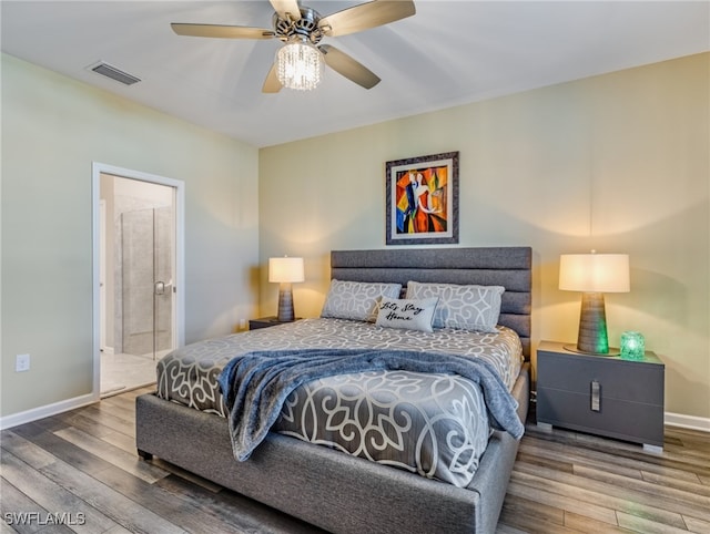 bedroom with ceiling fan, connected bathroom, and hardwood / wood-style floors