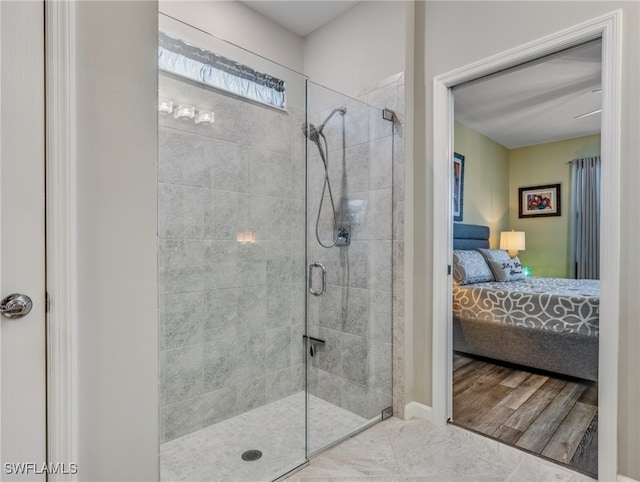 bathroom featuring hardwood / wood-style flooring and an enclosed shower