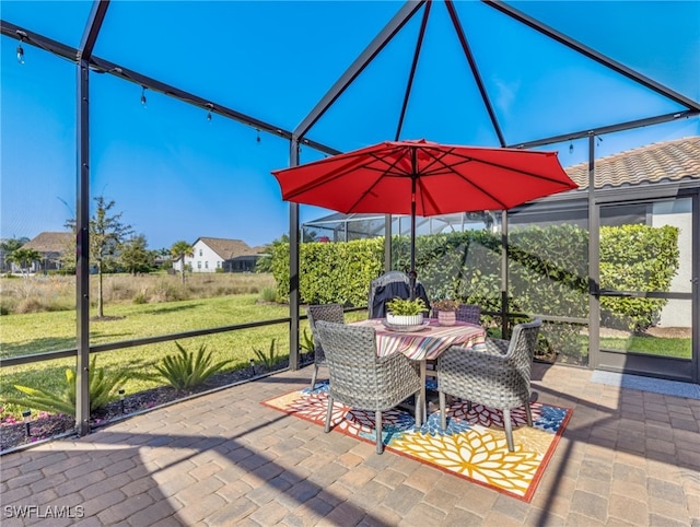 view of patio / terrace featuring a lanai