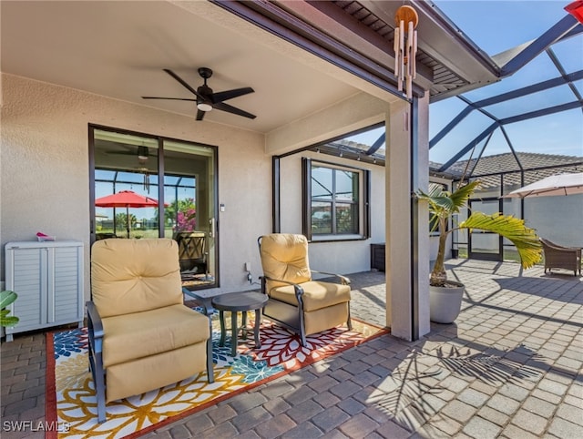 view of patio / terrace with ceiling fan and glass enclosure