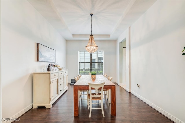 dining room featuring a chandelier, a tray ceiling, and dark hardwood / wood-style flooring