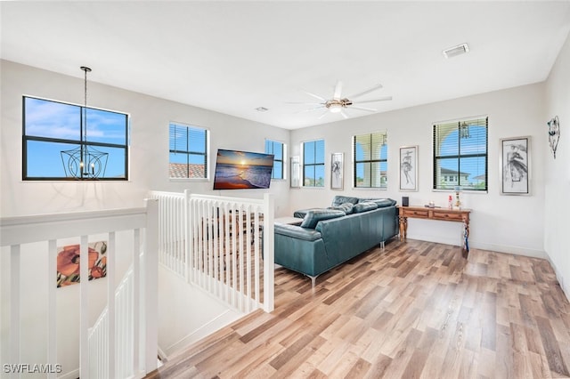 living room with light hardwood / wood-style floors and ceiling fan