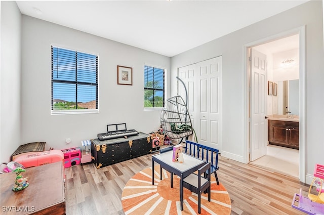 playroom featuring sink and hardwood / wood-style flooring