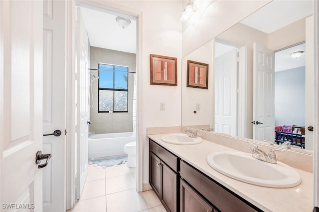 full bathroom featuring vanity, toilet, tiled shower / bath combo, and tile patterned floors