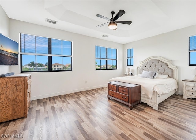 bedroom with light hardwood / wood-style floors and ceiling fan