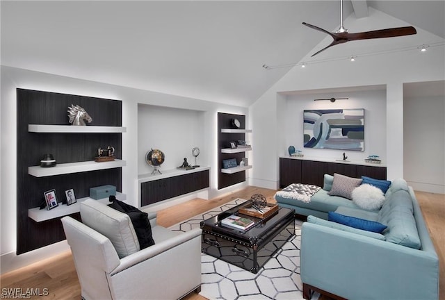 living room with ceiling fan, light hardwood / wood-style floors, lofted ceiling with beams, and built in shelves