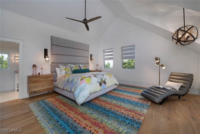 bedroom featuring high vaulted ceiling, light hardwood / wood-style flooring, and ceiling fan