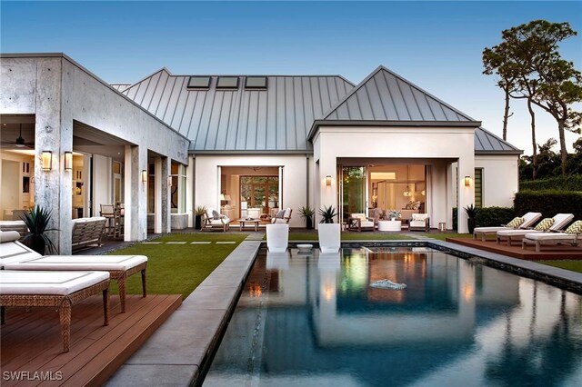 581 Myrtle Rd, Naples, FL 34108 - rear view of property featuring a standing seam roof, outdoor lounge area, an outdoor pool, and a metal roof