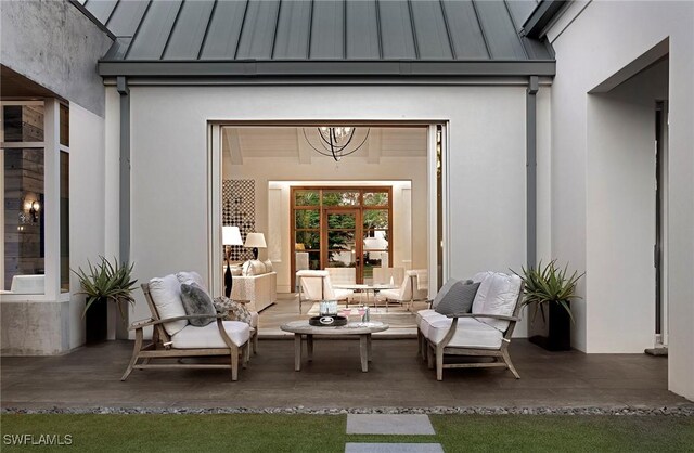 581 Myrtle Rd, Naples, FL 34108 - view of exterior entry with a standing seam roof, a metal roof, and stucco siding