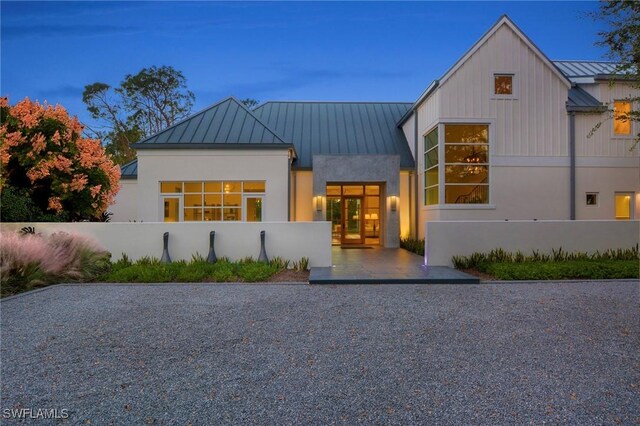 581 Myrtle Rd, Naples, FL 34108 - view of front facade with a standing seam roof, a metal roof, and stucco siding