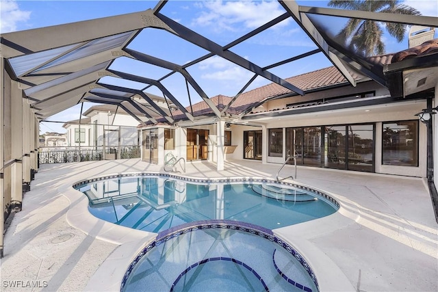 view of pool with a lanai, an in ground hot tub, and a patio