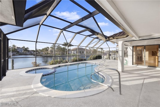 view of swimming pool with an in ground hot tub, a patio, a water view, and a lanai