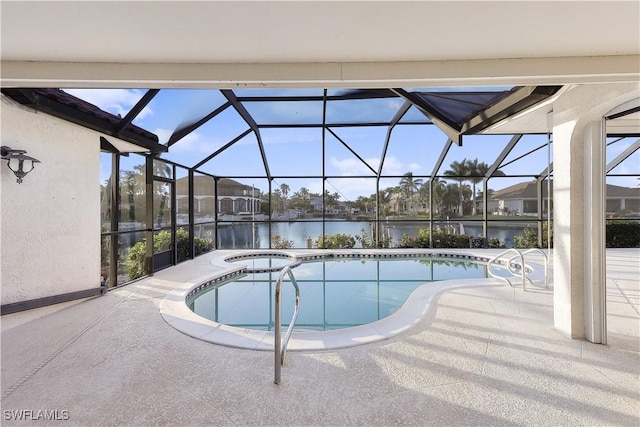 view of pool with a lanai, a patio area, a water view, and a jacuzzi