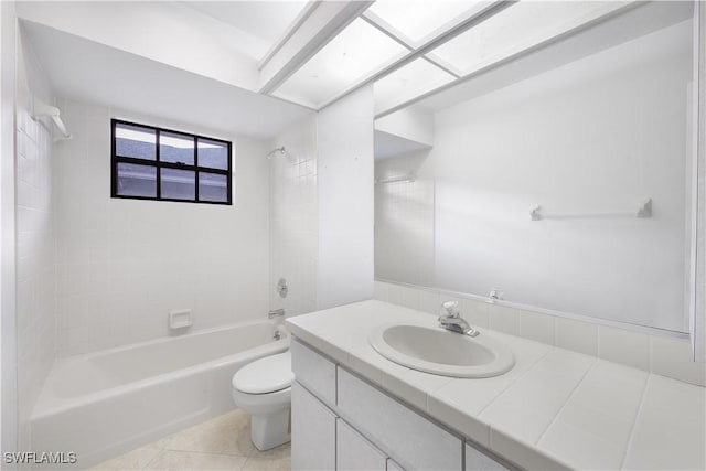 full bathroom featuring vanity, tile patterned floors, tiled shower / bath combo, and toilet