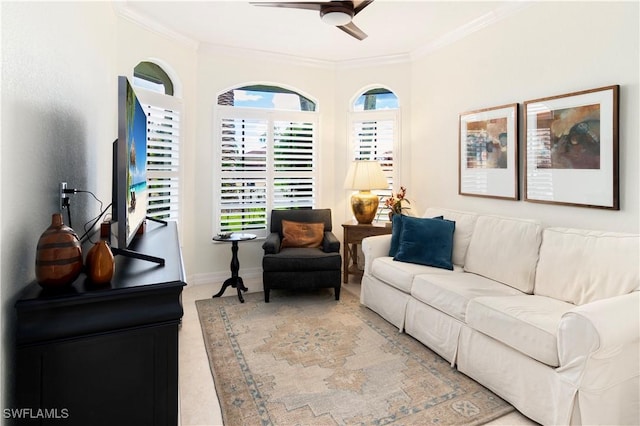 carpeted living room featuring ceiling fan and ornamental molding