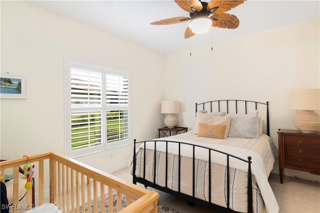 tiled bedroom featuring ceiling fan