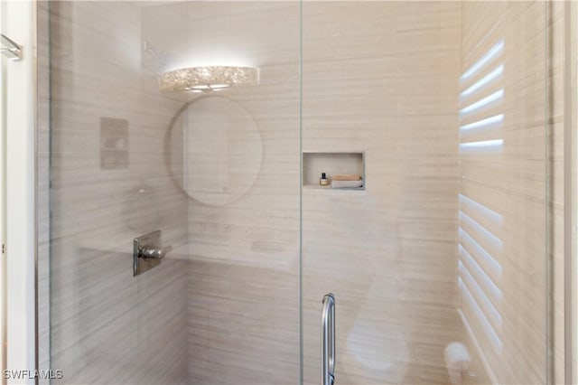 bathroom with a shower with shower door