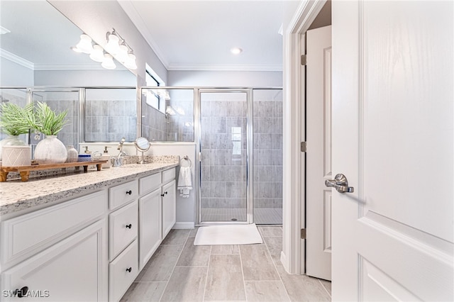 bathroom featuring vanity, ornamental molding, and a shower with door