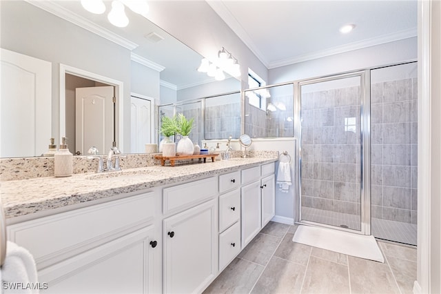 bathroom with crown molding, tile patterned flooring, vanity, and a shower with shower door