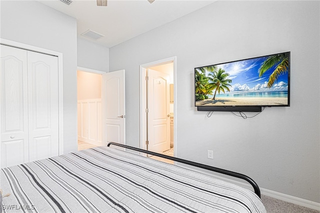 unfurnished bedroom featuring a closet, light colored carpet, and connected bathroom