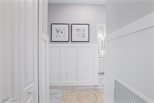 corridor featuring a textured ceiling