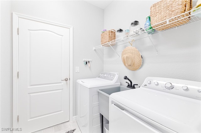 laundry area featuring independent washer and dryer and light tile patterned floors