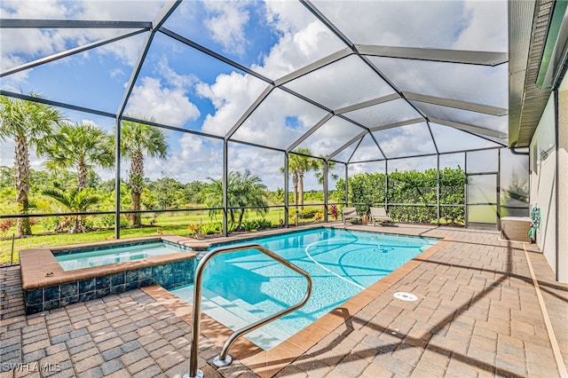 view of swimming pool with an in ground hot tub, a patio, and a lanai