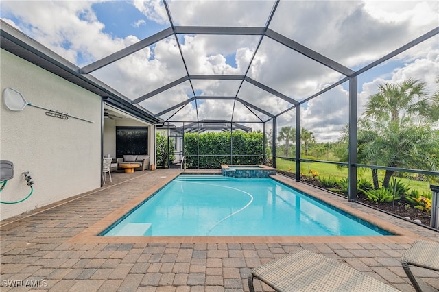 view of swimming pool featuring an in ground hot tub, a patio, and glass enclosure