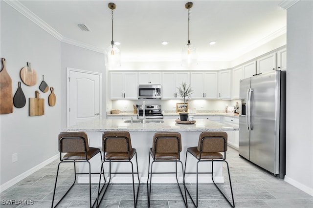 kitchen featuring white cabinets, an island with sink, appliances with stainless steel finishes, and sink