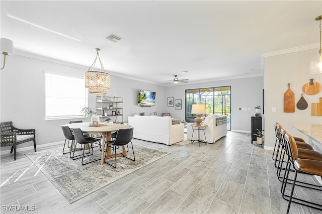 dining room with ceiling fan, light hardwood / wood-style flooring, and crown molding