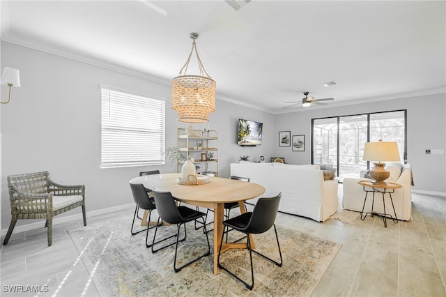 dining room featuring ceiling fan with notable chandelier and ornamental molding