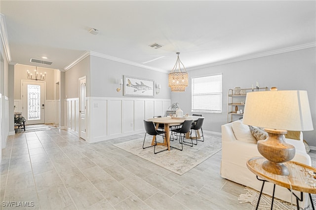 dining area featuring crown molding and a chandelier