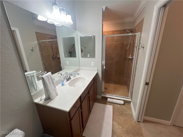 bathroom with tile patterned flooring, crown molding, a shower with shower door, and vanity