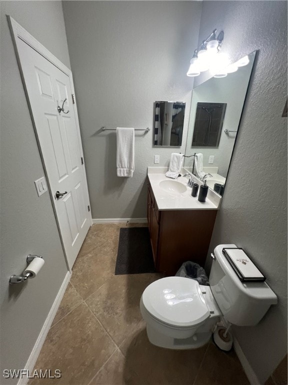 bathroom with tile patterned floors, vanity, and toilet