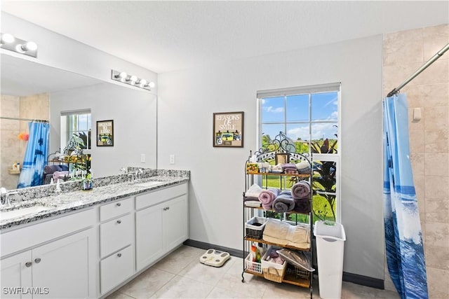 bathroom with vanity, tile patterned floors, a wealth of natural light, and curtained shower