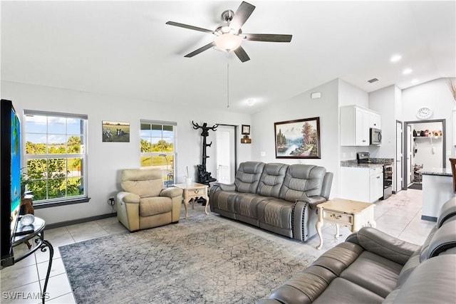 tiled living room featuring ceiling fan and vaulted ceiling