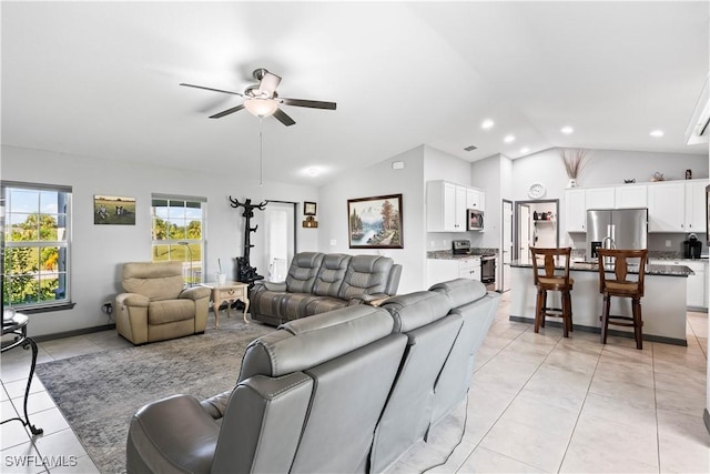 tiled living room featuring vaulted ceiling and ceiling fan