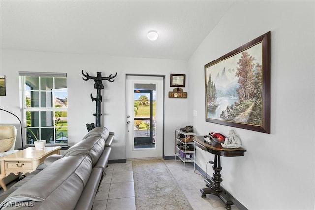 interior space with lofted ceiling and light tile patterned flooring