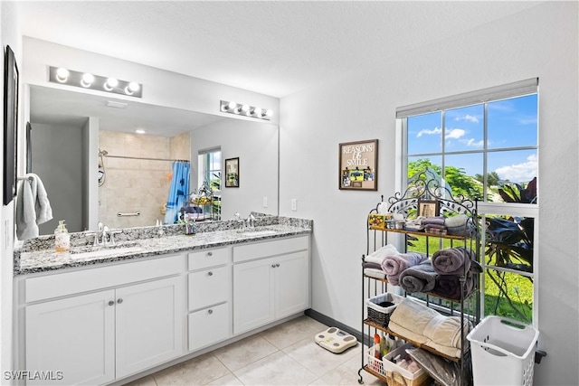 bathroom featuring vanity, tile patterned floors, and walk in shower