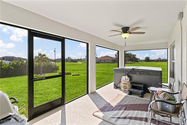 sunroom featuring ceiling fan