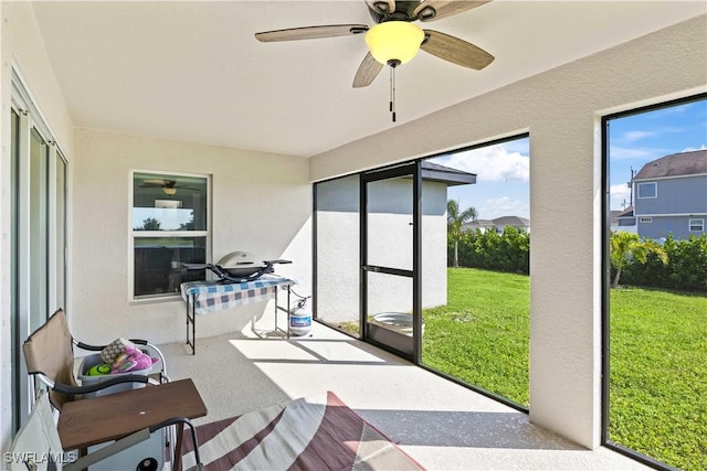 sunroom featuring ceiling fan